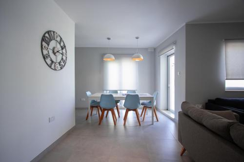 a living room with a table and chairs and a couch at The Three Trees Apartments in Sliema