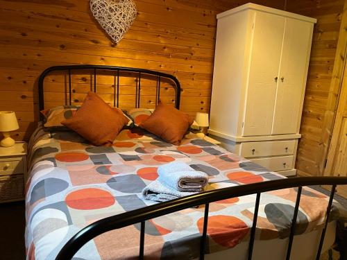 a bedroom with a bed in a wooden room at Wye View Lodge, Hay View Lodges in Hereford