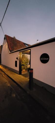 a white building with a sign on the side of it at Sea-renity 23 met sauna en jacuzzi in Eggewaartskapelle