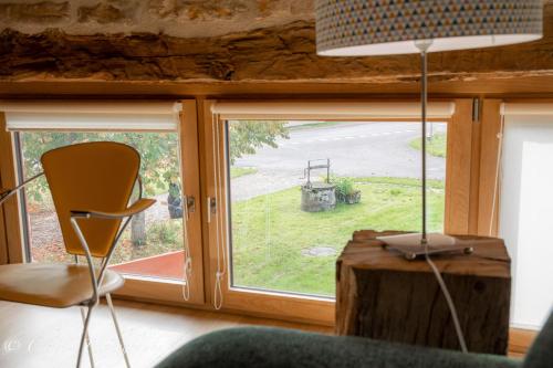 a room with a window with a chair and a table at Chez Agnès in Chailly-sur-Armançon