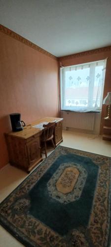 a room with a table and a rug and a window at Arthome Oxelösund in Oxelösund