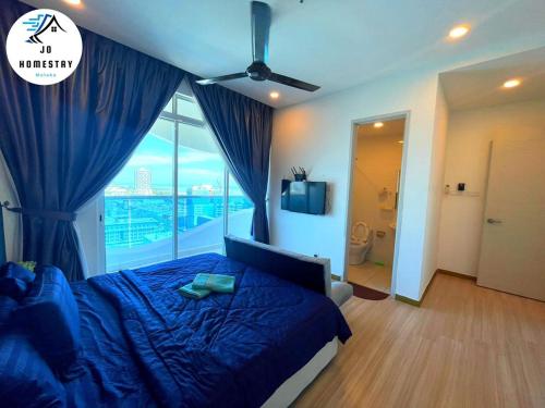a bedroom with a blue bed and a large window at THE WAVE 3 ROOMS & 2 BATH CONDO - Near JONKER in Melaka