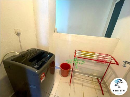 a bathroom with a washing machine and a potted plant at THE WAVE 3 ROOMS & 2 BATH CONDO - Near JONKER in Melaka