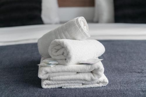 a stack of towels sitting on top of a table at Privilege Suite in Tal-Pietà