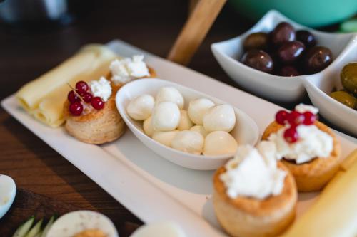 a tray filled with different types of food on a table at Privilege Suite in Tal-Pietà