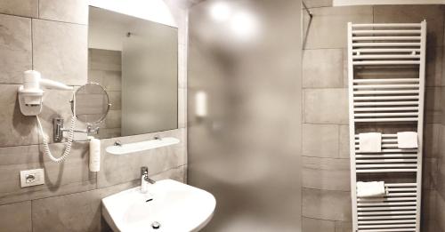 a bathroom with a sink and a mirror at Hotel Cantaleone in San Michele allʼAdige