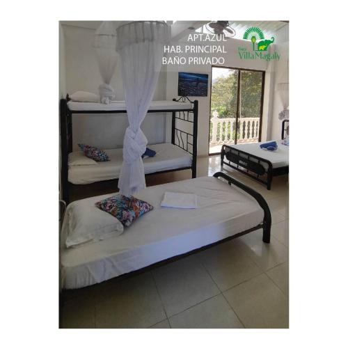 a bedroom with two beds and a sign that reads had principal bandung at FINCA VILLA MAGALY en medio de la Naturaleza in Melgar