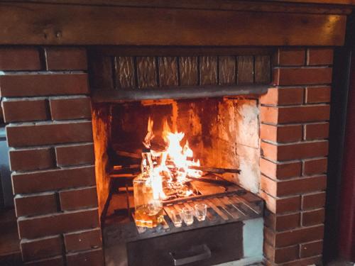 a brick oven with a fire in it at Vikendice Stara Pruga in Gornji Milanovac
