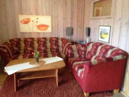 a living room with a couch and a coffee table at Ferienwohnung Ida in Kobbellück