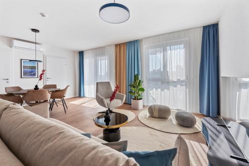 a living room with a couch and a table at Karl und Anton Boutique Apartments in Vienna