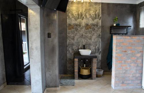a bathroom with a sink and a wall at A Step Ahead in Klerksdorp