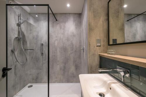 a bathroom with a shower and a sink at Royal National Hotel in London