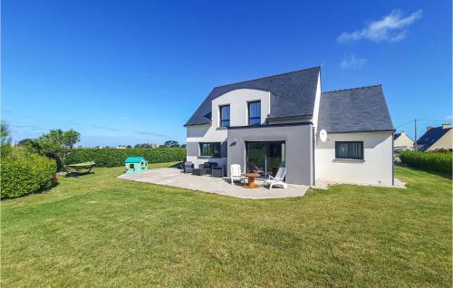 ein weißes Haus mit einem großen Garten mit Gras in der Unterkunft Holiday Home Lilia Plouguerneau With Sea View 02 in Plouguerneau