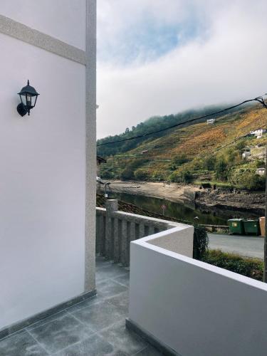 a view of a river from a house with a wall at Casa Amodiño in Belesar