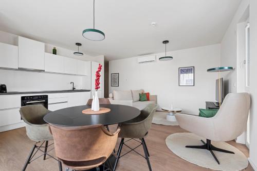 a kitchen and living room with a table and chairs at Karl und Anton Boutique Apartments in Vienna