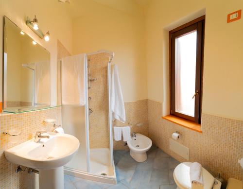 a bathroom with a sink and a shower and a toilet at Solares Case Vacanze in Ustica