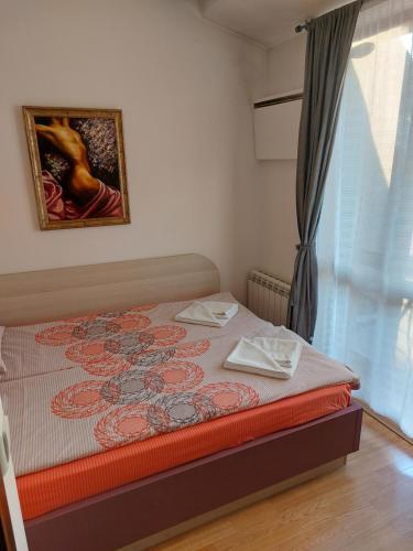 a bedroom with a bed with two towels on it at Apartment Budapeshta in Sofia