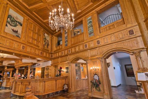 a large room with a chandelier in a building at Mercure Sighisoara Binderbubi Hotel & Spa in Sighişoara
