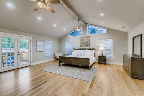 a bedroom with a bed and a ceiling fan at NEW 4 BDRM Home off St Mary’s Mins To Pearl/River! in San Antonio