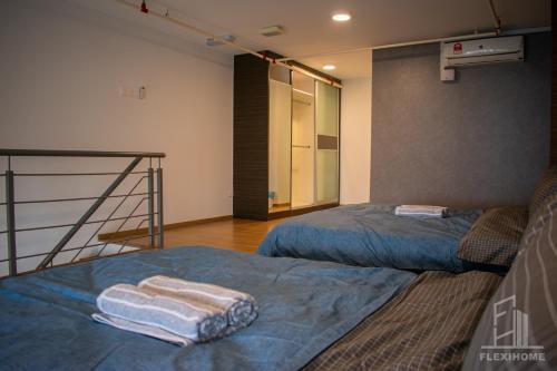 two beds in a room with towels on them at NETFLIX-Pinnacle PJ, Fantastic City View, 1-6 Guests Designed Duplex Home by Flexihome-MY in Petaling Jaya