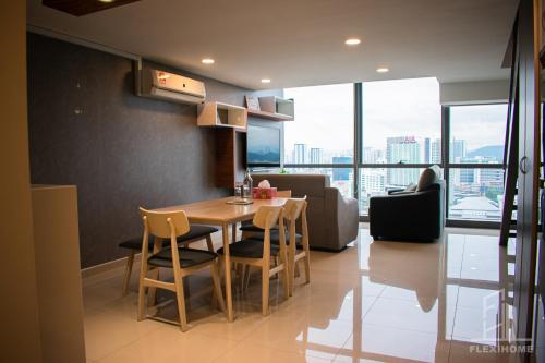a kitchen and dining room with a table and chairs at NETFLIX-Pinnacle PJ, Fantastic City View, 1-6 Guests Designed Duplex Home by Flexihome-MY in Petaling Jaya