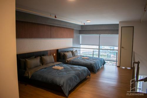 a bedroom with two beds and a balcony at NETFLIX-Pinnacle PJ, Fantastic City View, 1-6 Guests Designed Duplex Home by Flexihome-MY in Petaling Jaya