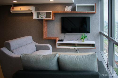 a living room with a couch and a tv at NETFLIX-Pinnacle PJ, Fantastic City View, 1-6 Guests Designed Duplex Home by Flexihome-MY in Petaling Jaya