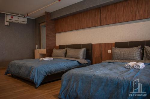 a bedroom with two beds with blue comforters at NETFLIX-Pinnacle PJ, Fantastic City View, 1-6 Guests Designed Duplex Home by Flexihome-MY in Petaling Jaya