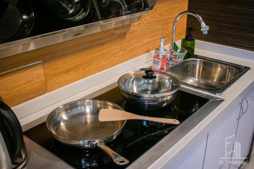 a kitchen sink with two pots and a strainer at NETFLIX-Pinnacle PJ, Fantastic City View, 1-6 Guests Designed Duplex Home by Flexihome-MY in Petaling Jaya