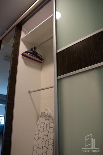 a closet with a sliding glass door with a surfboard at NETFLIX-Pinnacle PJ, Fantastic City View, 1-6 Guests Designed Duplex Home by Flexihome-MY in Petaling Jaya