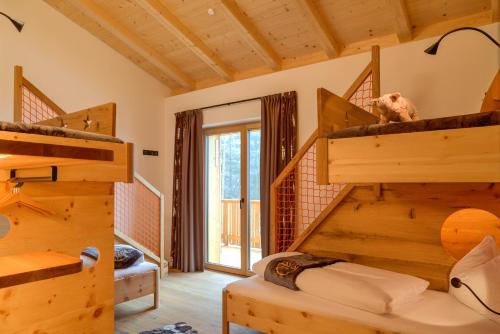 a room with wooden bunk beds in a house at SchartnerAlm in Collalbo
