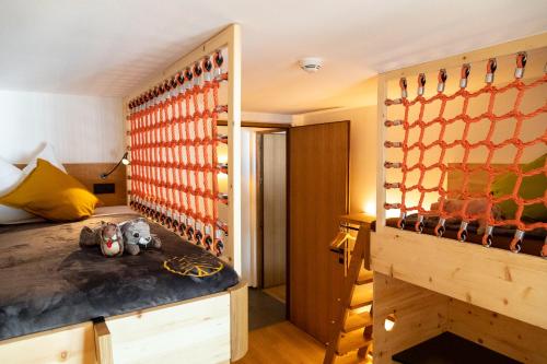 a bedroom with a bed and a room with a wall at SchartnerAlm in Collalbo