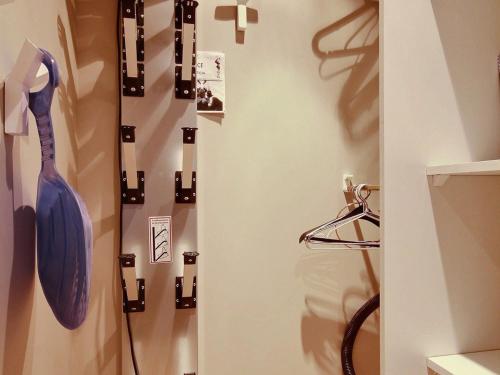 a bathroom with a shower with a blue umbrella on a wall at Appartement spacieux rénové avec WiFi et au pied des pistes - FR-1-455-11 in La Plagne