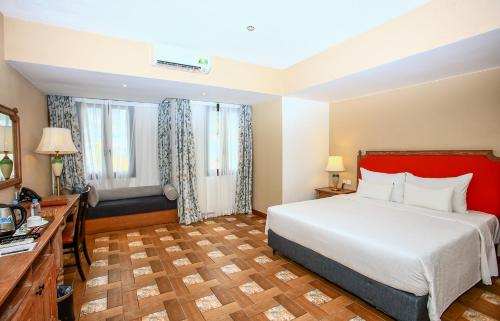 a hotel room with a large bed and a desk at Venus Hotel Tam Đảo in Tam Ðảo