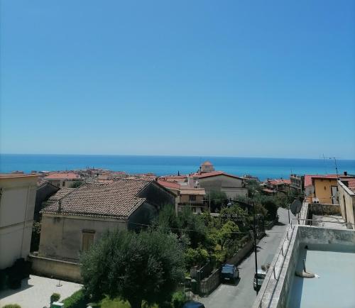 a view of a city with the ocean in the background at Casa Quieta in Marina di Camerota