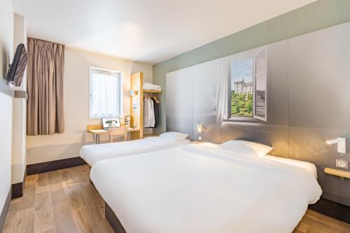 Un ou plusieurs lits dans un hébergement de l'établissement B&B HOTEL Tours Nord 2 La petite Arche