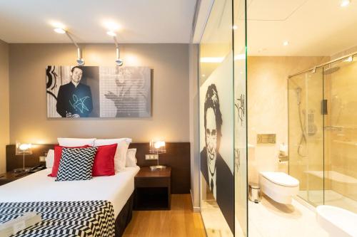 a hotel room with a bed and a shower at Hotel Zinema7 in San Sebastián