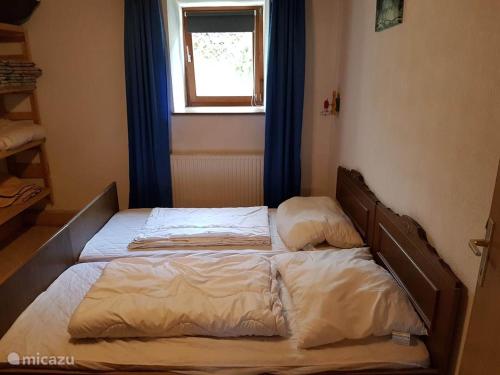 two twin beds in a bedroom with a window at Haus Leonie in Bramberg am Wildkogel
