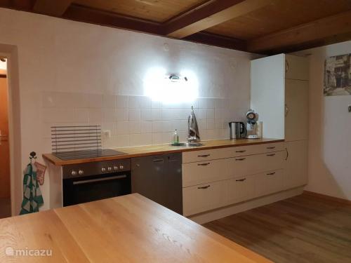 a kitchen with a sink and a stove top oven at Haus Leonie in Bramberg am Wildkogel