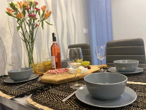 un tavolo con ciotole e bicchieri da vino sopra di Apartament Majakowskiego DG a Dąbrowa Górnicza