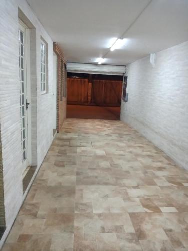 an empty hallway with a tile floor in a building at Apts centro Ubatuba in Ubatuba