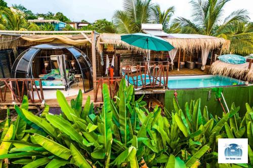 a resort with a swimming pool and an umbrella at Caraibes insolite in Sainte-Luce