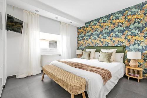 a bedroom with a large bed with a floral wall at New Heima Colon Square in Madrid