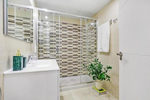 a bathroom with a shower and a sink and a toilet at New Heima Colon Square in Madrid