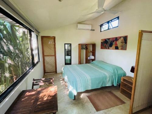 a bedroom with a bed and a window at Centro Sati Bungalos in Cuatunalco