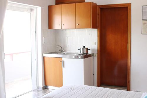 a small kitchen with a sink and a counter at Ostria Rooms in Palaiochora