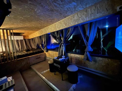 a room with a fish tank with blue lights at Caraibes insolite in Sainte-Luce