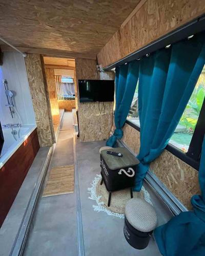 a view of the inside of a tiny house with a curtain at Caraibes insolite in Sainte-Luce