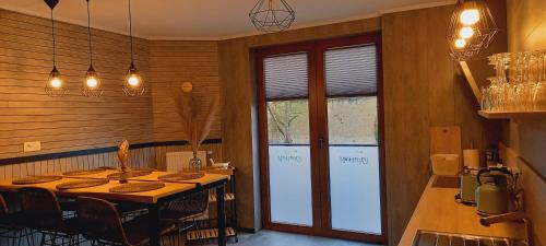 a dining room with a table and a window at Gîte Chez Simone in Houffalize