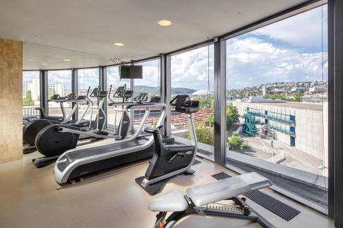 a gym with cardio machines and a large window at Quality Hotel Brno Exhibition Centre in Brno